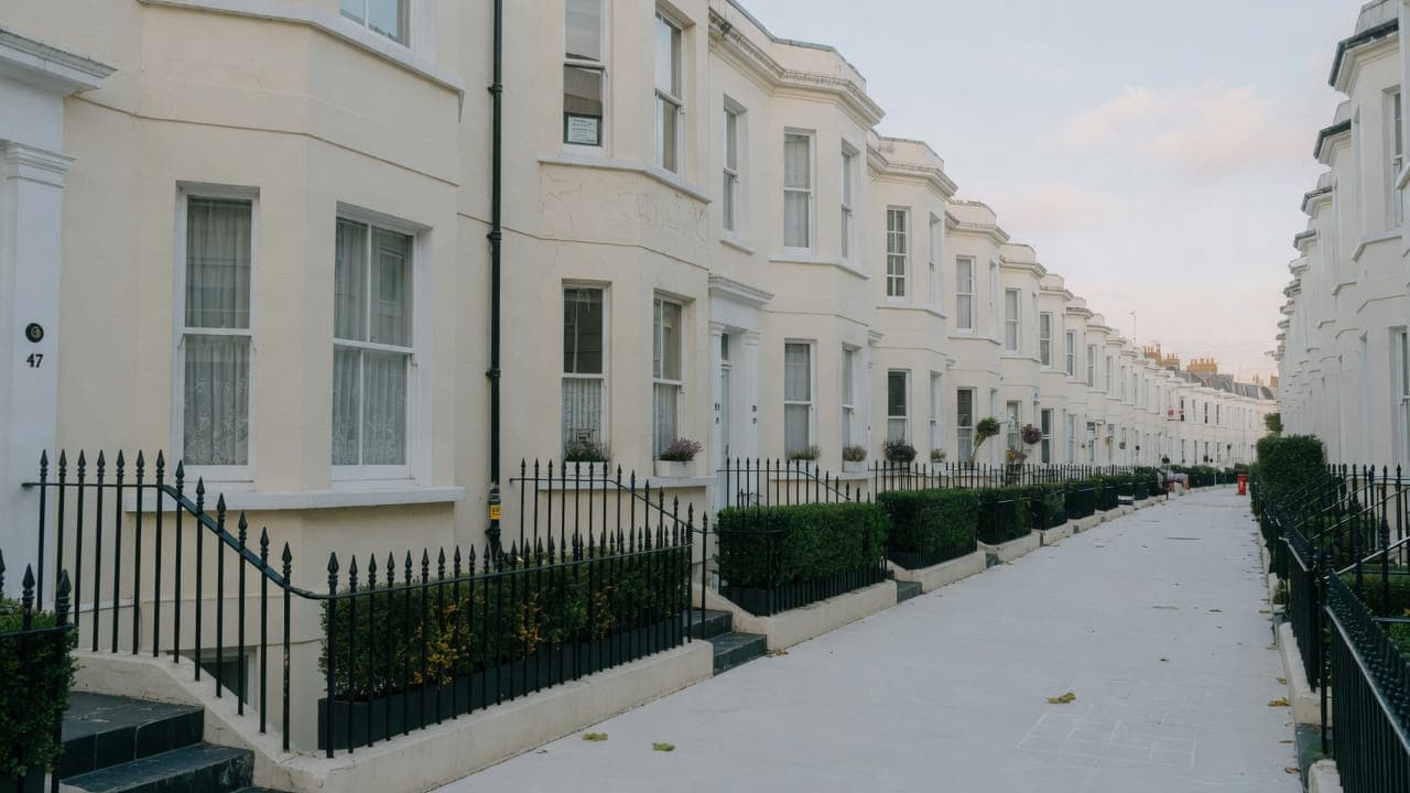 Cream stucco bays and box hedges, typical of quieter Kilburn streets, NW6